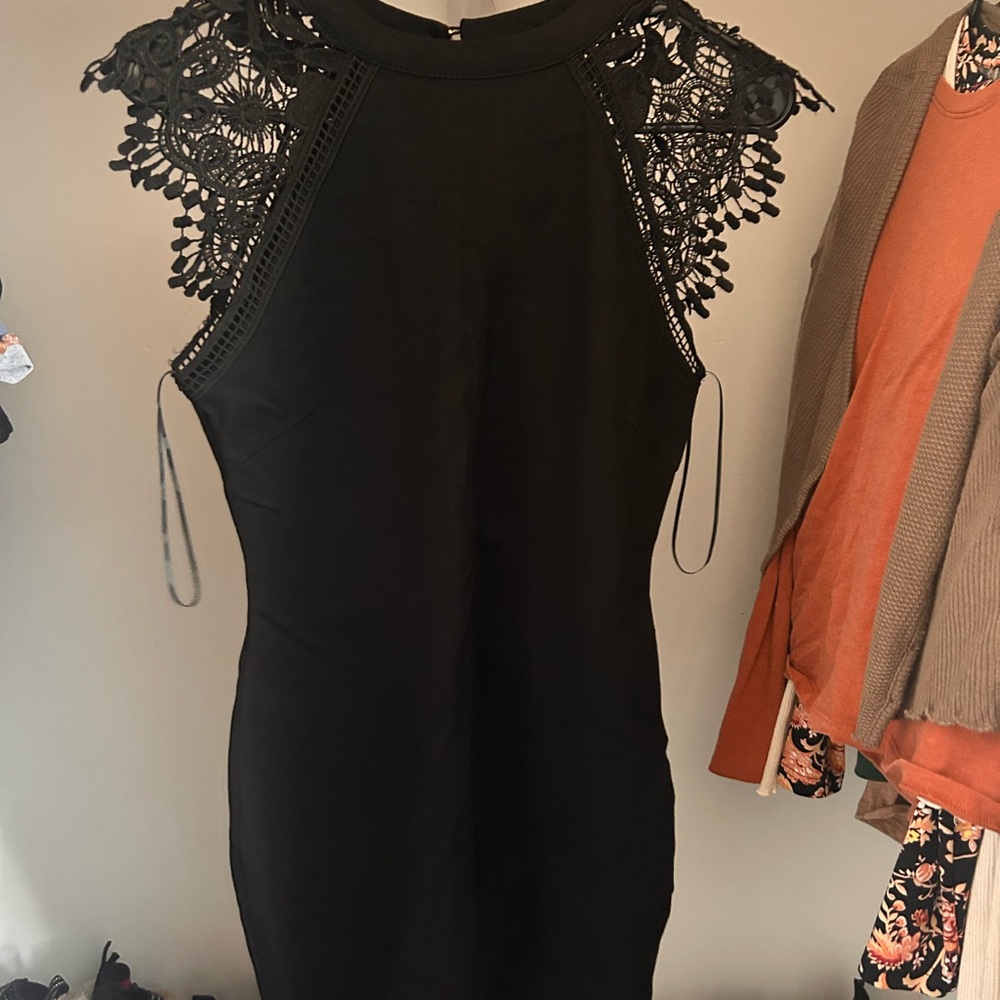 Little black dress with lace shoulders.